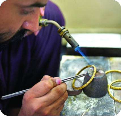 Technician reviewing a wax prototype for jewellery casting
