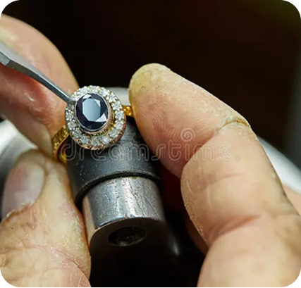 Jeweller assembling components at the bench