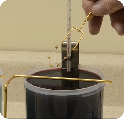 Artisan applying a lacquer finish to a jewellery piece